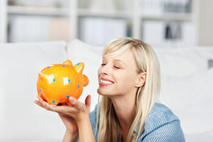 A-lady-holding-her-piggy-bank-to-signify-savings